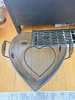Top view showing heart shape, wire mesh construction, handles, leaf details
