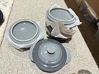 Stacked gray stoneware mini cocottes with one lid shown