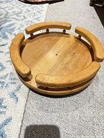 Top view of circular wooden lazy Susan with raised curved rails