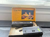 Both Kodak cameras, Ektra 1 in original box, Safari Funshooter 110 with wrist strap