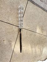 Full view of letter opener showing crystal handle and metal blade