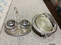 Butter dish and condiment server showing ornate silver-tone metal and glass inserts