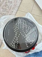 Top view of round black LED light fixture showing clear lens and internal LED array