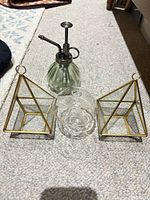 two brass framed glass pyramid terrariums, ribbed glass plant mister with metal pump, clear glass mushroom