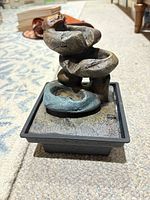 Front view of resin tabletop fountain showing multicolor cascade design and base