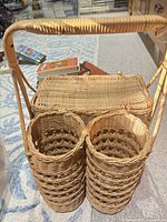 Front view showing basket, handle, and dual cylindrical holders