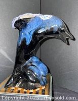 Front view of glazed dolphin figurine