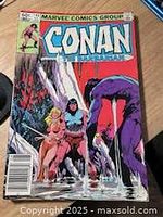 Front cover showing Conan vs purple creature by waterfall