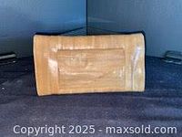 Front view of tan eel skin wallet closed