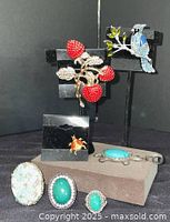 Overall view showing brooches, rings and pendant