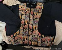 Full view of front of jacket showing design, sleeves, zipper