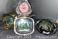 Group shot of four ashtrays showing shapes and logos