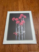 Full view of framed Carnations portrait on wooden floor