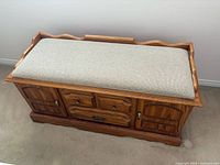 Cedar-lined bench chest closed showing cushioned seat and wood exterior