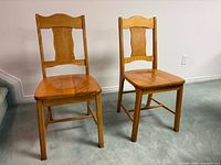 Front view of both hardwood chairs showing design and finish