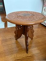 Table assembled showing carved top and legs