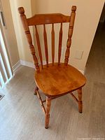 Front view of one chair showing overall style and finish