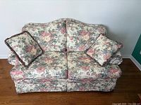 Front view of Decor-Rest floral loveseat with pillows