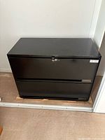 full view of black metal cabinet front closed
