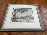 Framed artwork showing Ottawa skyline on wooden floor