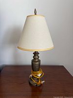 Full view of metal table lamp with shade and cord