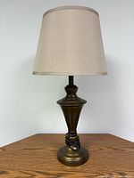 Full view of bronze-tone table lamp with shade