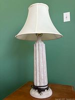 Full view of lamp showing fluted column base, shade, and cord