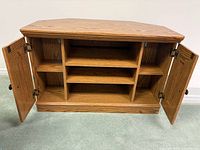 TV stand interior view with doors open showing shelves