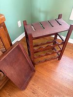 Wine rack frame and separate tray leaning against it