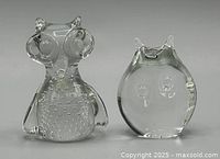 Front view of both clear glass owl figurines