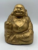 Front view of gold-tone clay Buddha statue