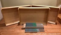 Three wooden drawers stood upright with metal slide rails in front