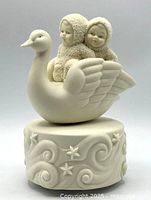 Full view of music box showing swan and two Snowbabies on decorative base