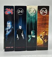 Front spines of four "24" DVD season box sets
