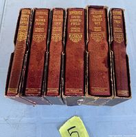 Spines of six Collins Dickens volumes showing titles and slipcases