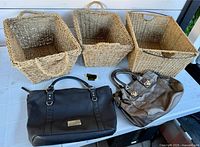 Overview of three baskets and two handbags on table