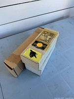 Two small cardboard boxes of hockey cards, one closed, one with labels