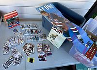 Overview of table with hockey cards, Gretzky poster, storage bin, Lions In Winter book