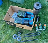 Overall lot showing two boxed torches, assembled torch, fuel cans, poles and hardware
