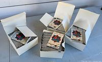 Multiple white boxes filled with sealed silver foil hockey card packs