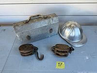 Overall lot view showing hard hat, lunchbox and two pulleys