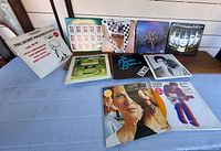 Front covers of ten vinyl LPs laid out on table