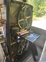 Full view of Craftsman 12" band saw-sander with open side panel showing wheels and work table