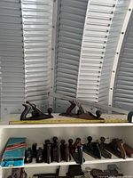 Shelf with multiple wooden and metal hand planes