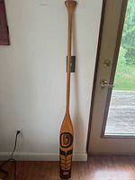 Full view of paddle leaning against wall