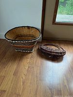 Large flared basket and oval magazine holder on floor