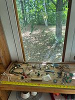 Overview of all jewelry pieces on wooden surface with tape measure