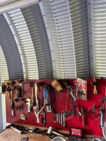 Wide view of pegboard with majority of hand tools hanging