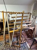 Full view of Leclerc floor loom with treadles, cloth beam and accessory frame at side