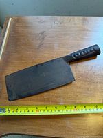 Full view of cleaver on table with measuring tape, shows blade size and handle